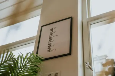 a framed picture on a wall next to a window at Hotel Heye 130 in Amsterdam