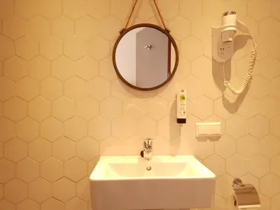 a bathroom with a sink and a mirror and a phone at Hotel Heye 130 in Amsterdam