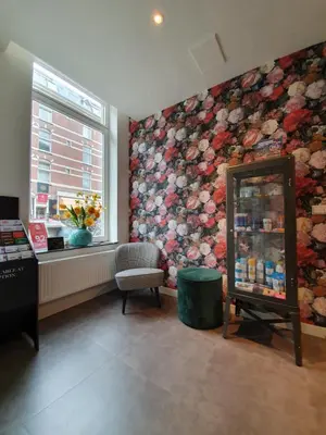 a waiting room with a flower mural on the wall at Hotel Heye 130 in Amsterdam