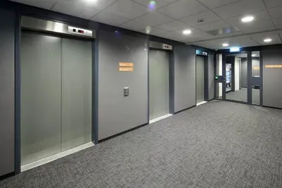 a row of elevator doors in an office building at easyHotel Amsterdam Zaandam in Zaandam