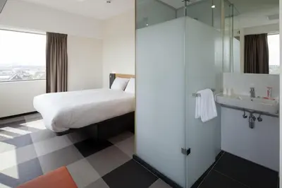 a hotel room with a bed and a sink at easyHotel Amsterdam Zaandam in Zaandam