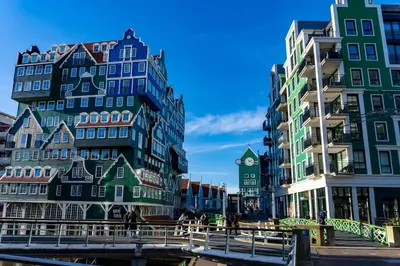 a group of buildings next to a river with a bridge at easyHotel Amsterdam Zaandam in Zaandam