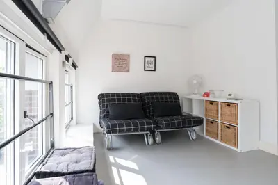 a living room with a couch and a chair at Tweede Laurierdwarsstraat Apartment in Amsterdam