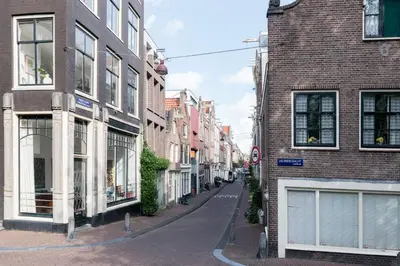 an empty street in a city with buildings at Tweede Laurierdwarsstraat Apartment in Amsterdam