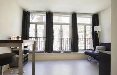 a room with a window with a desk and a chair at Tweede Laurierdwarsstraat Apartment in Amsterdam