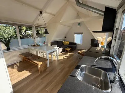 a kitchen and living room in an attic at BeachVibes in Egmond aan Zee
