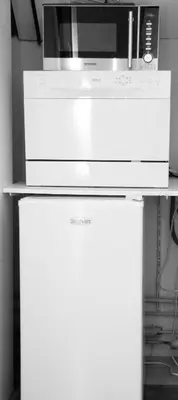 a microwave oven sitting on top of a refrigerator at Appartement Lefferts in Zandvoort