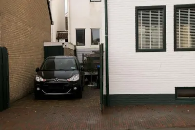 a black car parked next to a building at Appartement Lefferts in Zandvoort