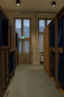 a room with a television and a room with a refrigerator at Shelter City Christian Hostel in Amsterdam