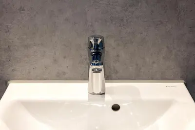 a bathroom sink with a faucet on top of it at Shelter City Christian Hostel in Amsterdam