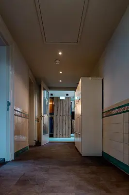 an empty hallway with a refrigerator in a building at Shelter City Christian Hostel in Amsterdam