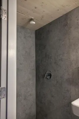 a shower with a shower head in a bathroom at Shelter City Christian Hostel in Amsterdam