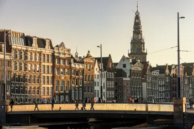 a bridge over a city with buildings and a clock tower at Shelter City Christian Hostel in Amsterdam