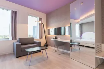 a hotel room with a bed and a desk and a chair at Park Inn by Radisson Amsterdam City West in Amsterdam