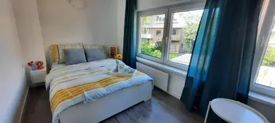 a small bedroom with a bed and a window at Sunny Guesthouse in Amsterdam