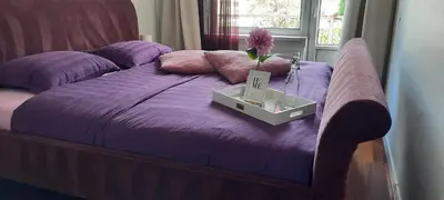 a purple bed with a box on top of it at Sunny Guesthouse in Amsterdam