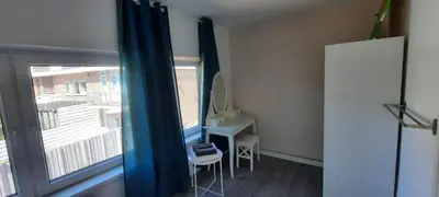 a room with a window with a desk and a mirror at Sunny Guesthouse in Amsterdam