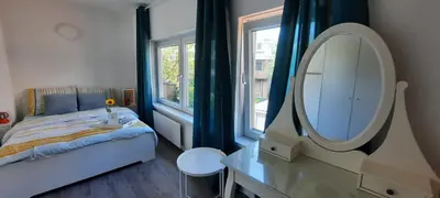 a bedroom with a bed and a mirror and a table at Sunny Guesthouse in Amsterdam