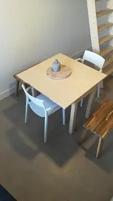a wooden table with two chairs and a hat on it at Terrace Apartment Cyclades Free Parking in Amsterdam