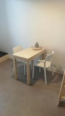 a wooden table with two white chairs and a table and a table and chairs at Terrace Apartment Cyclades Free Parking in Amsterdam