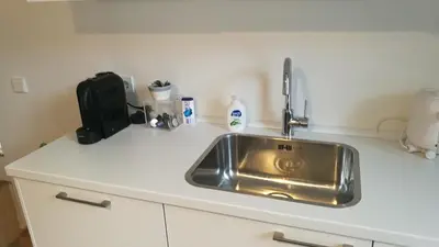 a kitchen counter with a stainless steel sink at Terrace Apartment Cyclades Free Parking in Amsterdam