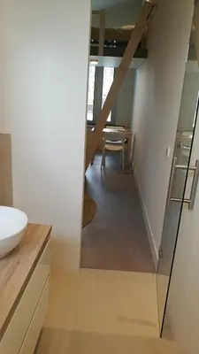 a bathroom with a sink and a hallway with a table at Terrace Apartment Cyclades Free Parking in Amsterdam