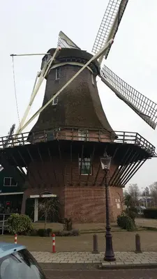 a large windmill in front of a building at Terrace Apartment Cyclades Free Parking in Amsterdam