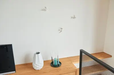 a room with a table with vases and a speaker at Lake View Apartment Amsterdam in Amsterdam