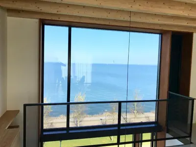a large window with a view of the ocean at Lake View Apartment Amsterdam in Amsterdam