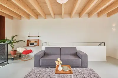 a living room with a couch and a table at Lake View Apartment Amsterdam in Amsterdam