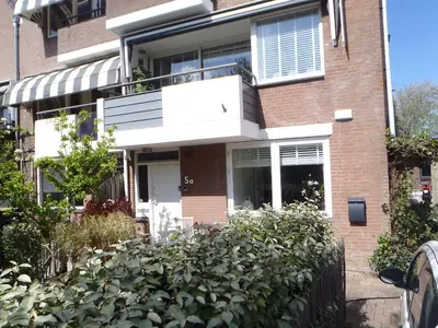 a brick house with a lot of plants in front of it at Holidaytime in Zandvoort