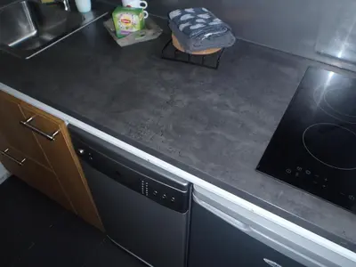 a kitchen counter with a dishwasher and a sink at Holidaytime in Zandvoort