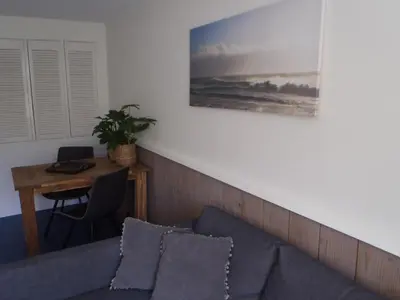 a living room with a couch and a table at Holidaytime in Zandvoort