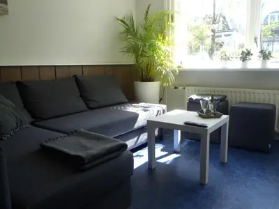 a living room with a couch and a table at Holidaytime in Zandvoort