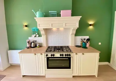 a kitchen with a stove top oven in a room at Maison Rue de la Mer in Zandvoort