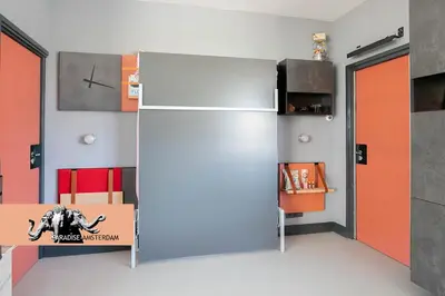 a room with a refrigerator and a table with a box at Paradise Amsterdam bungalow of 80 m2 with private pool - inclusive, parking, use of bikes, tourist tax and much more in Zandvoort