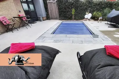 two bean bags sitting on a patio next to a pool at Paradise Amsterdam bungalow of 80 m2 with private pool - inclusive, parking, use of bikes, tourist tax and much more in Zandvoort