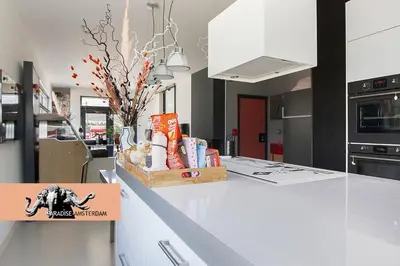 a kitchen with a white counter top in a kitchen at Paradise Amsterdam bungalow of 80 m2 with private pool - inclusive, parking, use of bikes, tourist tax and much more in Zandvoort