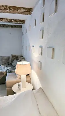 a bedroom with a bed and a lamp on a table at JoyJoyJoy the White Wilde ecolicious studio in a historic Canalhouse from 1799 with terrace at the canals in Amsterdam