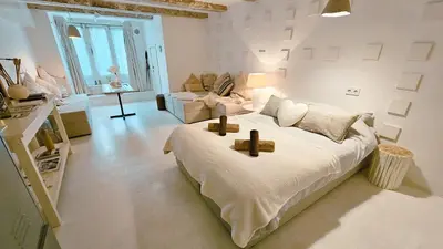 a white bedroom with a large bed with two crosses on it at JoyJoyJoy the White Wilde ecolicious studio in a historic Canalhouse from 1799 with terrace at the canals in Amsterdam