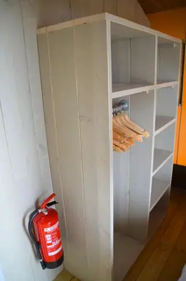 a white closet with a red car in it at Jachthaven Nieuwboer in Bunschoten