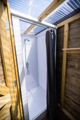 a shower with a glass door in a bathroom at Jachthaven Nieuwboer in Bunschoten