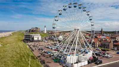 a ferris wheel at a carnival in a city at Aan Zee en Duin in Egmond aan Zee