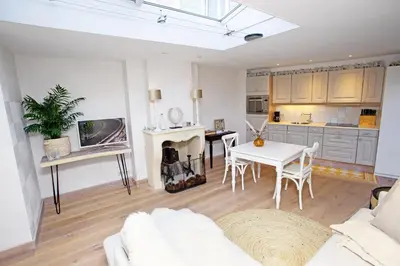 a living room with a white couch and a table at Aan Zee en Duin in Egmond aan Zee