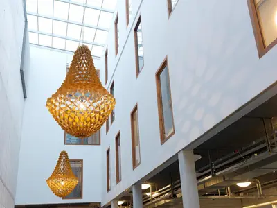 two large chandeliers hanging from the side of a building at Q-Factory Hotel in Amsterdam
