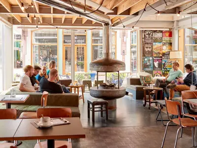 a group of people sitting in a restaurant at Q-Factory Hotel in Amsterdam