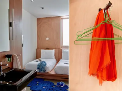 a hotel room with a bed and a towel hanging on a wall at Q-Factory Hotel in Amsterdam