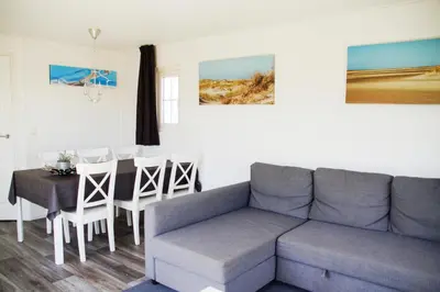 a living room with a couch and a table at Zee en duin in IJmuiden