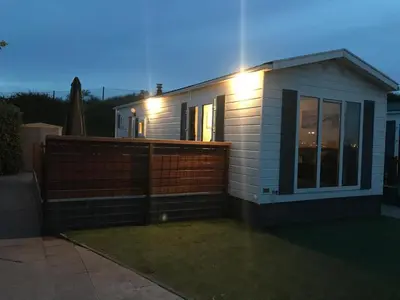 a small house with lights on the side of it at Zee en duin in IJmuiden