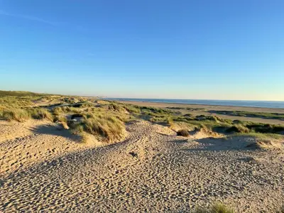 a sandy beach with the ocean in the background at Zee en duin in IJmuiden